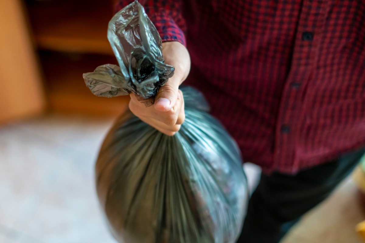 man holding trash bag