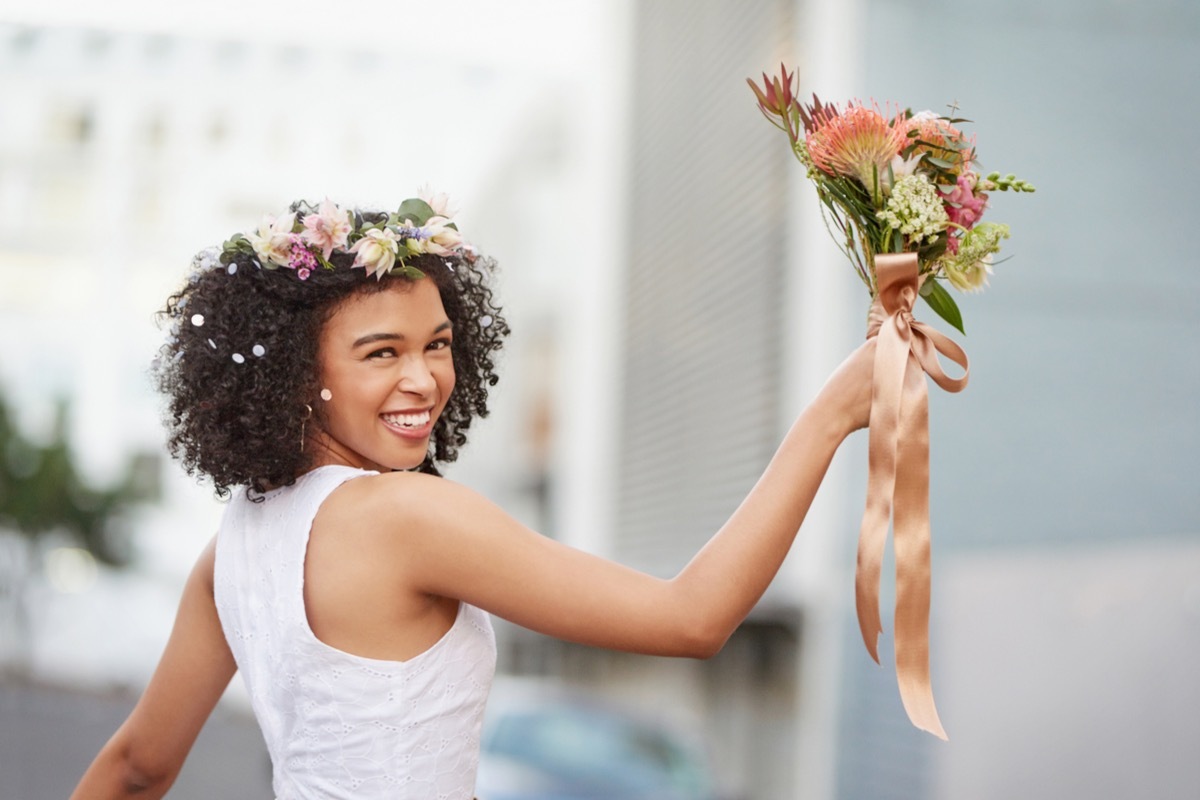 bride getting ready to toss bouquet