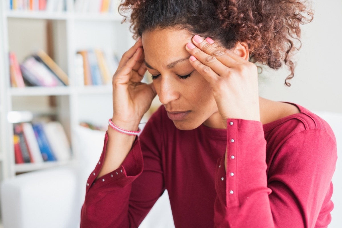 Woman suffering from terrible headache massaging temples