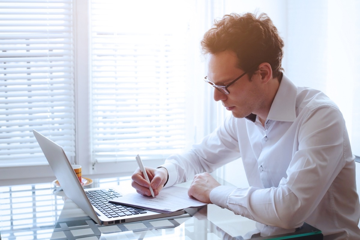 Responsible adult working on his computer at the office