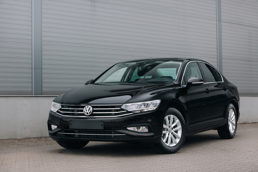 A dark blue Volkswagen Passat sitting in a parking garage