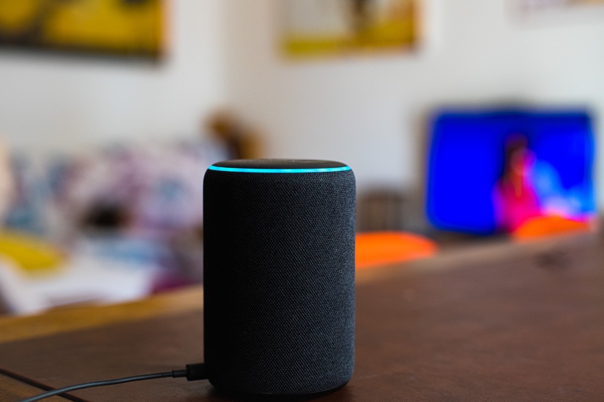 Rome, Italy, april 2020. Alexa smart home assistant device by Amazon close up connected in house living room selective focus background