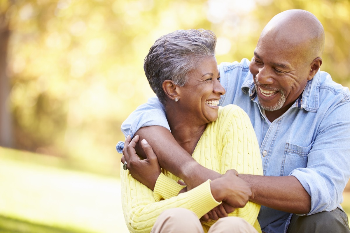 older black couple hugging outdoors