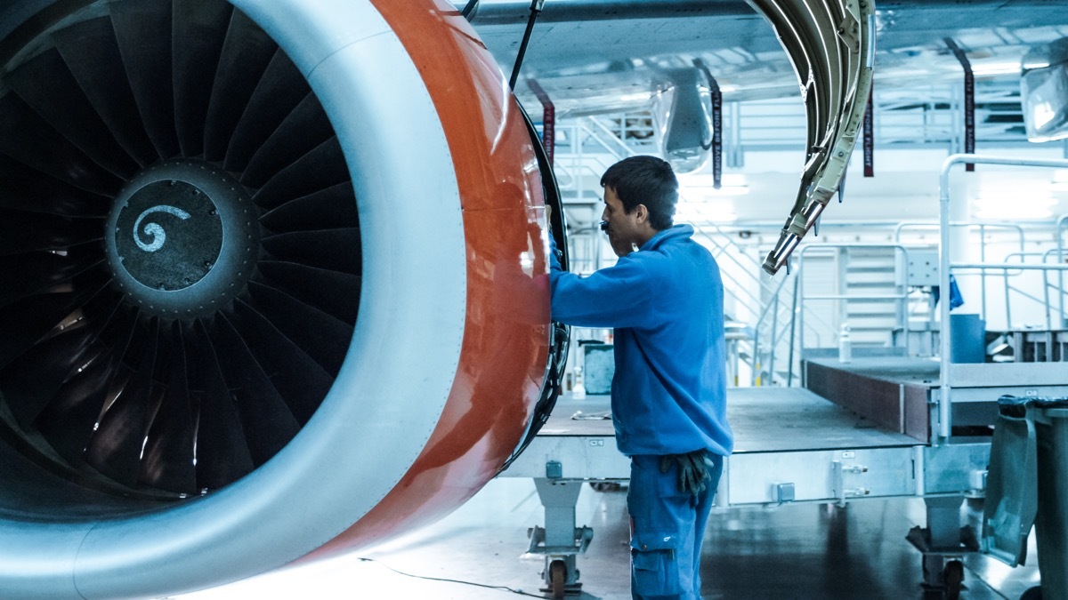 mechanic checking an airplane engine