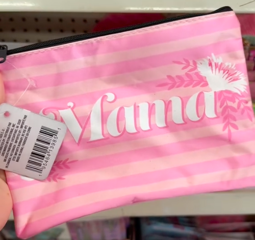 A shopper holds a pink cosmetic bag with the word 