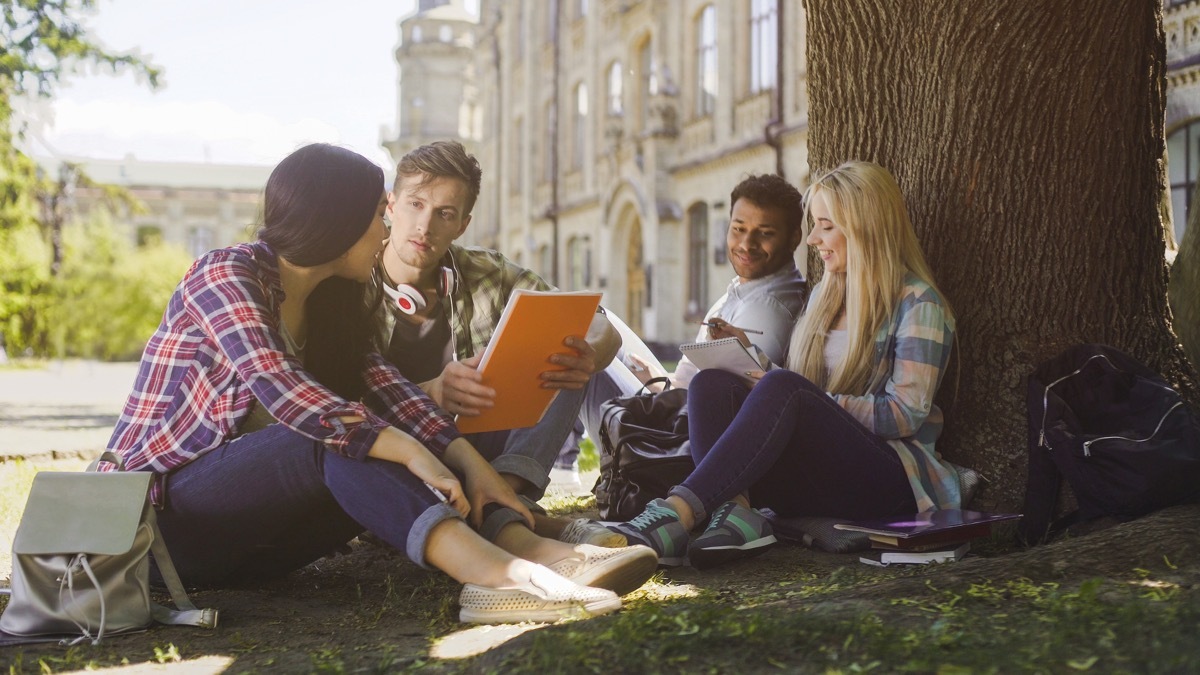 college student studying on the quad