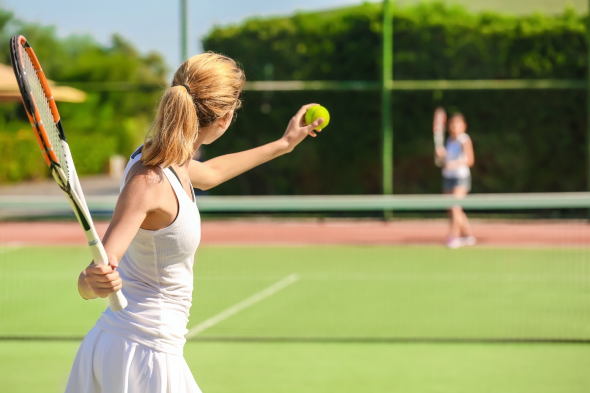 woman playing tennis on court