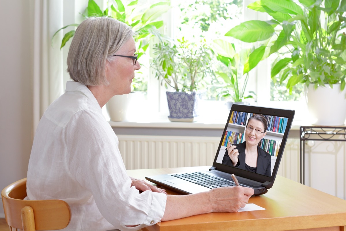 senior woman talking to doctor via video chat