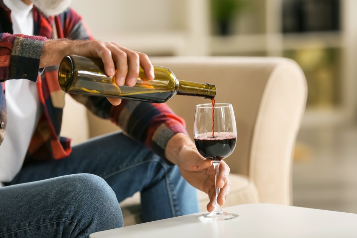 man pouring a glass of wine