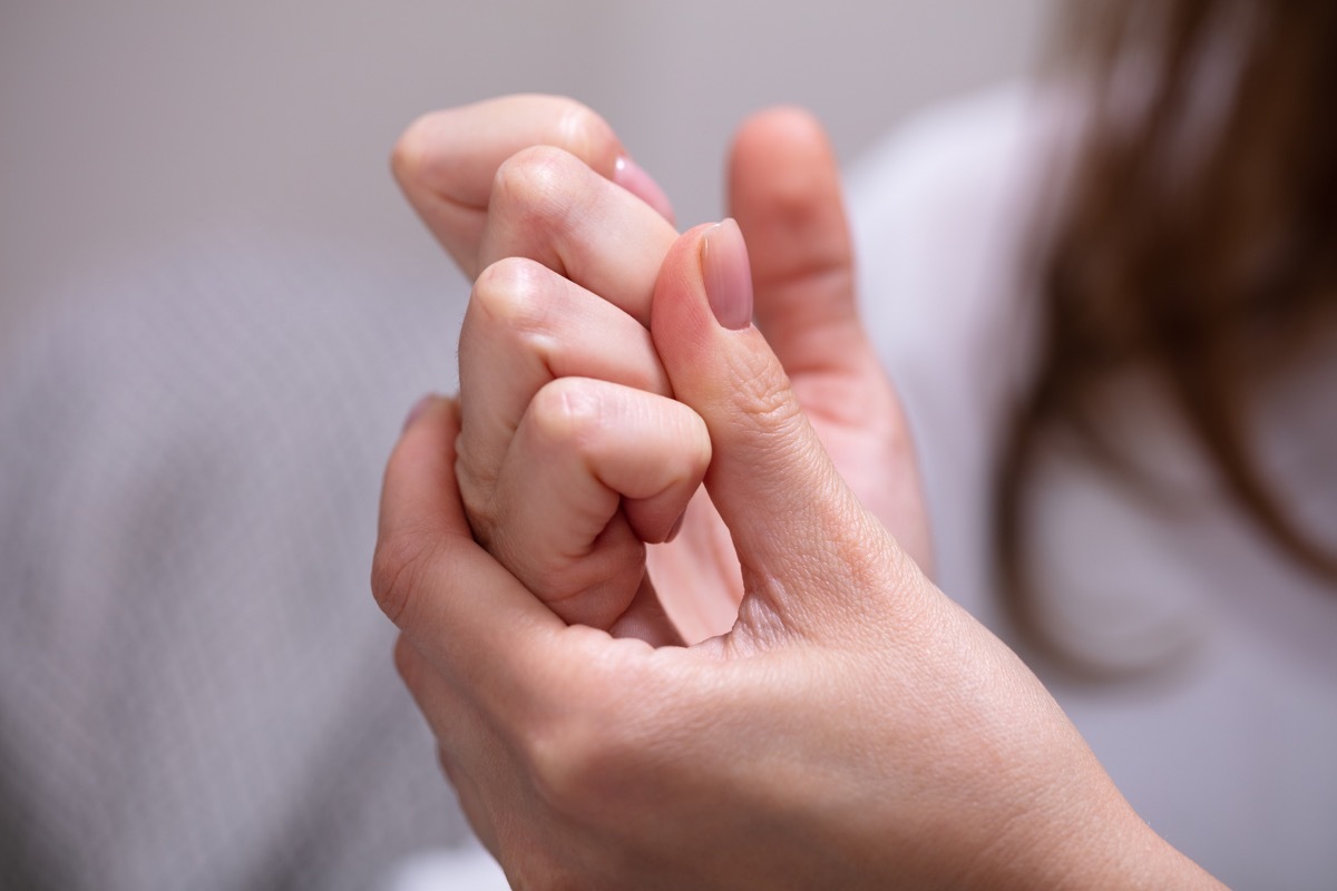 woman cracking her knuckles at home