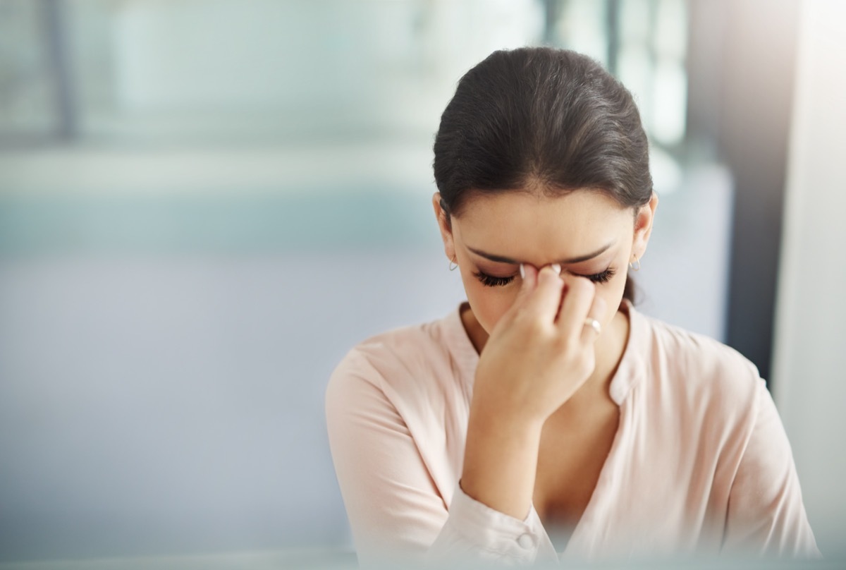 A businesswoman rubbing her eyes.