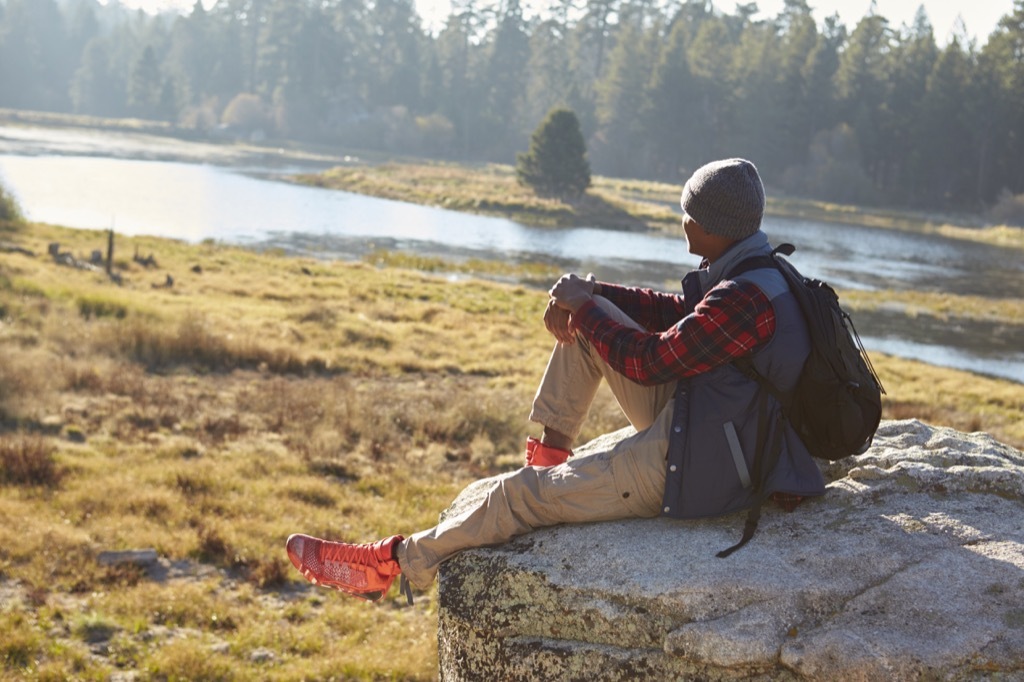 Man outside in nature, one of the surefire stress busters.