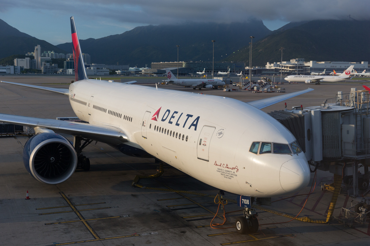 A Delta Air Lines plane sitting at a gate at an airport