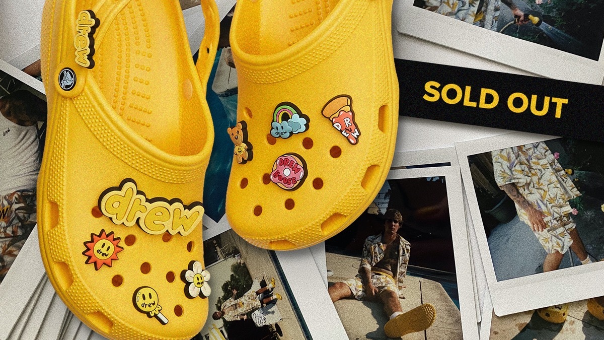 embellished yellow crocs next to a sign reading 