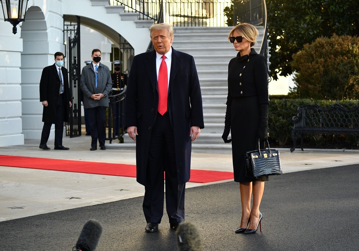 donald and melania trump stand outside white house