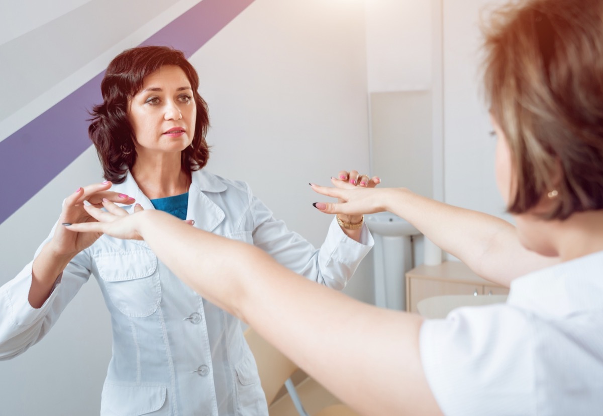 Neurologist testing patient's reflexes and nerves