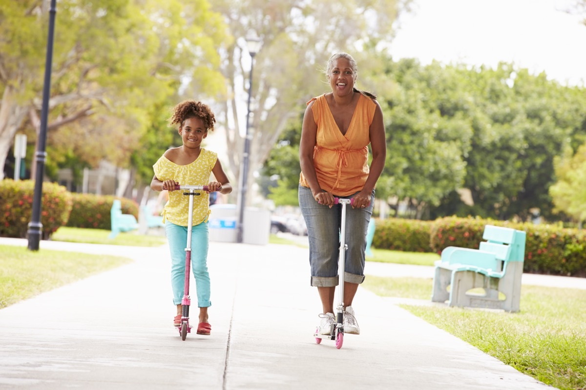 Grandma riding a scooter with granddaughter