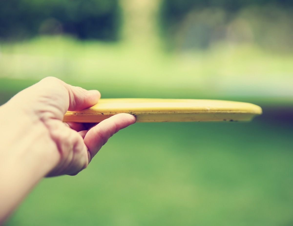 Hand holding frisbee