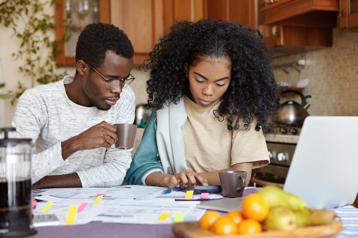 couple calculating taxes in kitchen