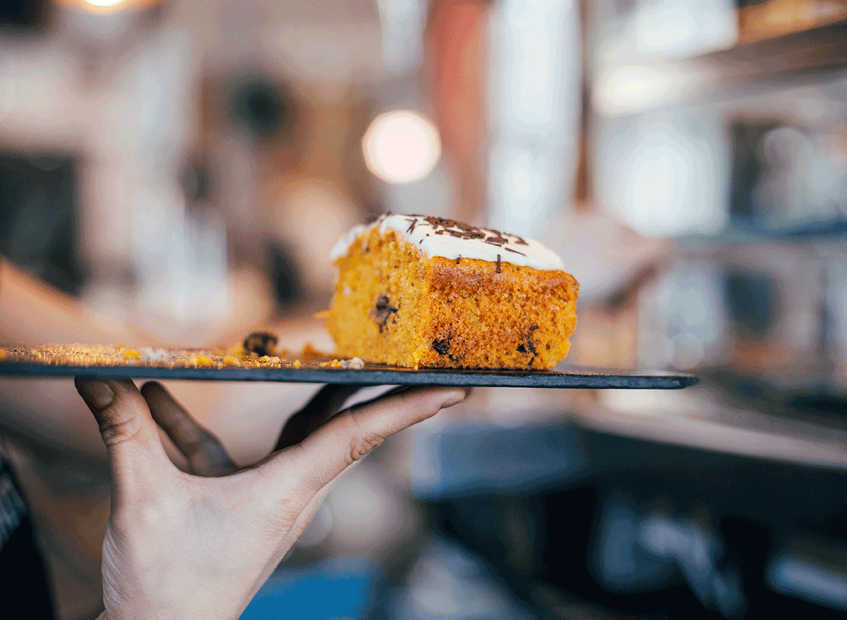 waiter carrying dessert tray with one hand