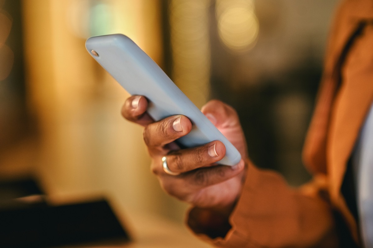 woman hands typing on phone, sending a text message online on social media.