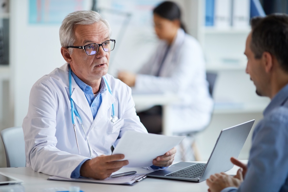 senior doctor talking to his patient and telling him what to do