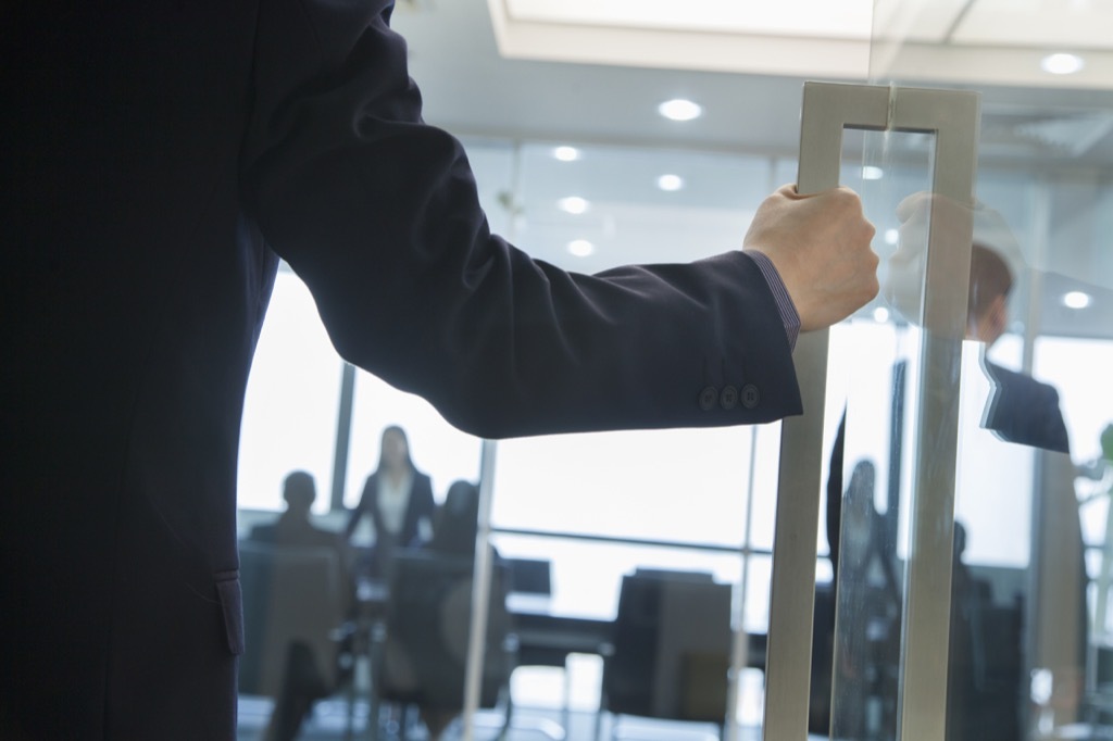 Man Standing Outside Office Signs Your Boss Wants to Fire You