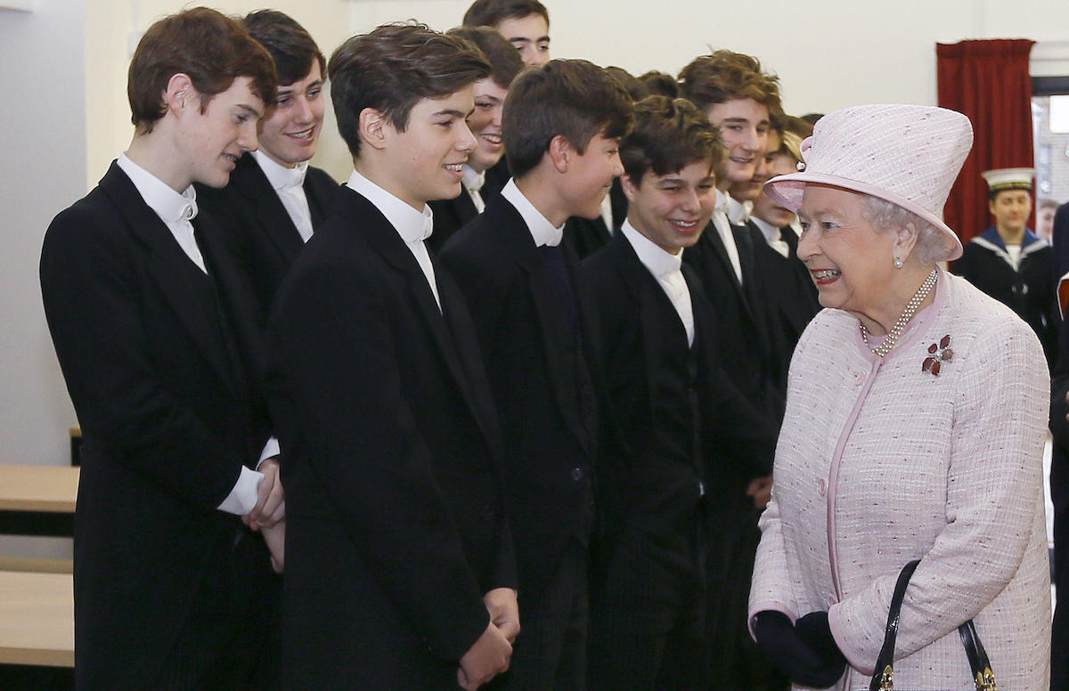 Queen Elizabeth II meets Eton pupil Arthur Chatto, grandson of her late sister Princess Margaret, during a visit to Holyport College near Maidenhead, Berkshire, in 2014.