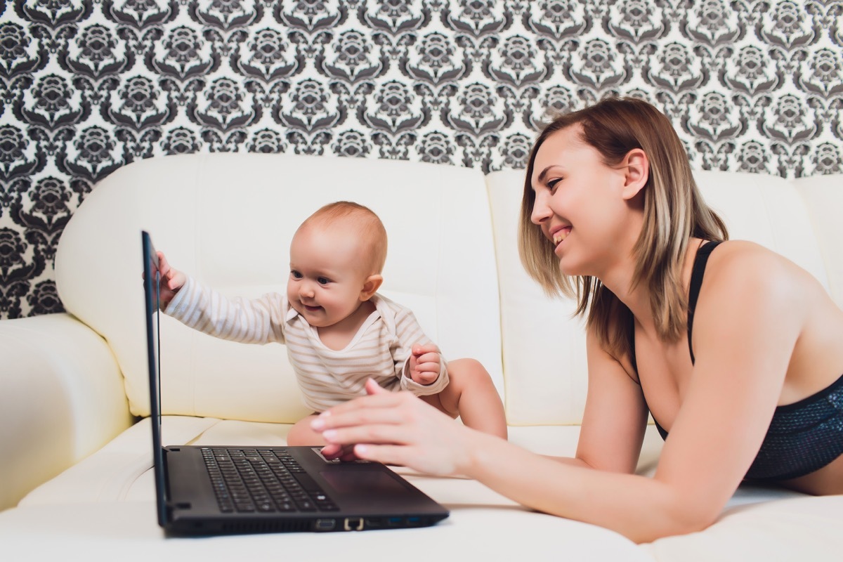 Mom on the Computer Sitting Next to Her Baby, ways parenting has changed.