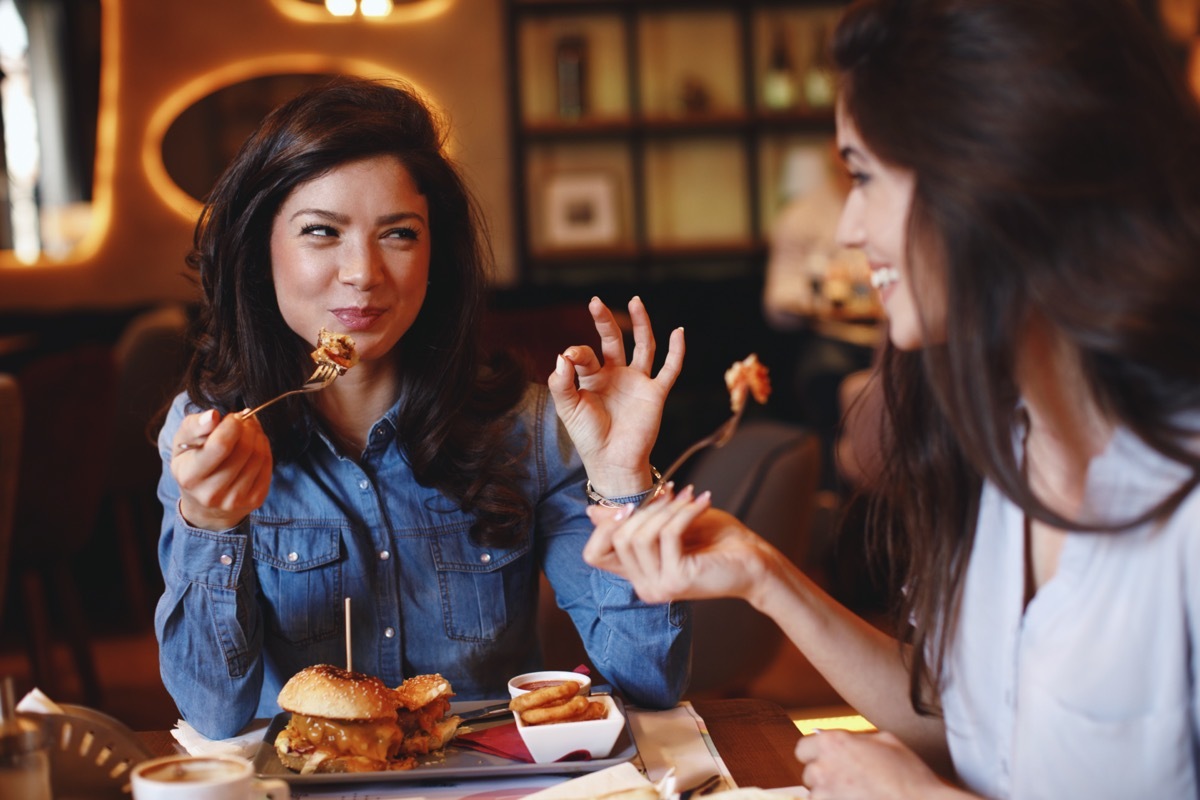 Two young women at a lunch in a restaurant