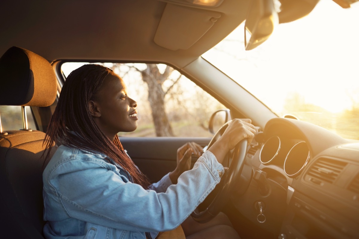 Side view of a woman driving the car