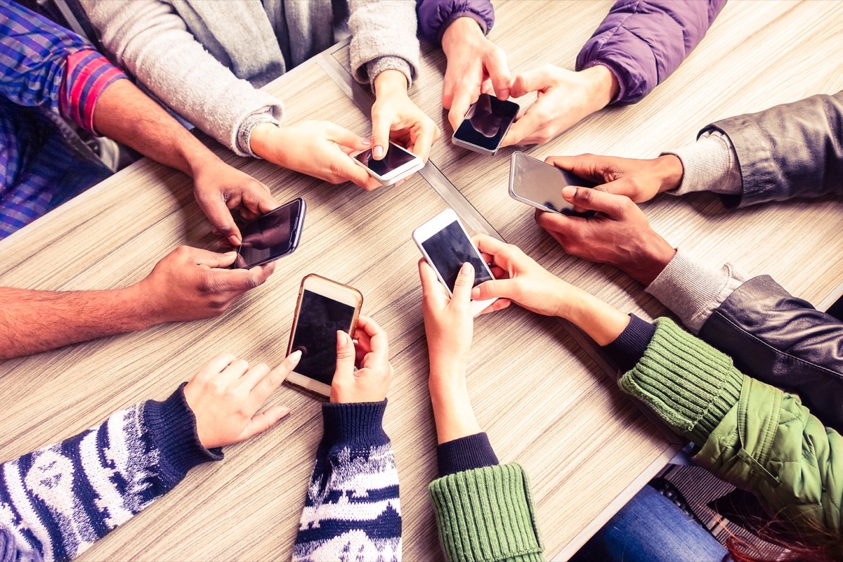 top view hands in circle with smartphones