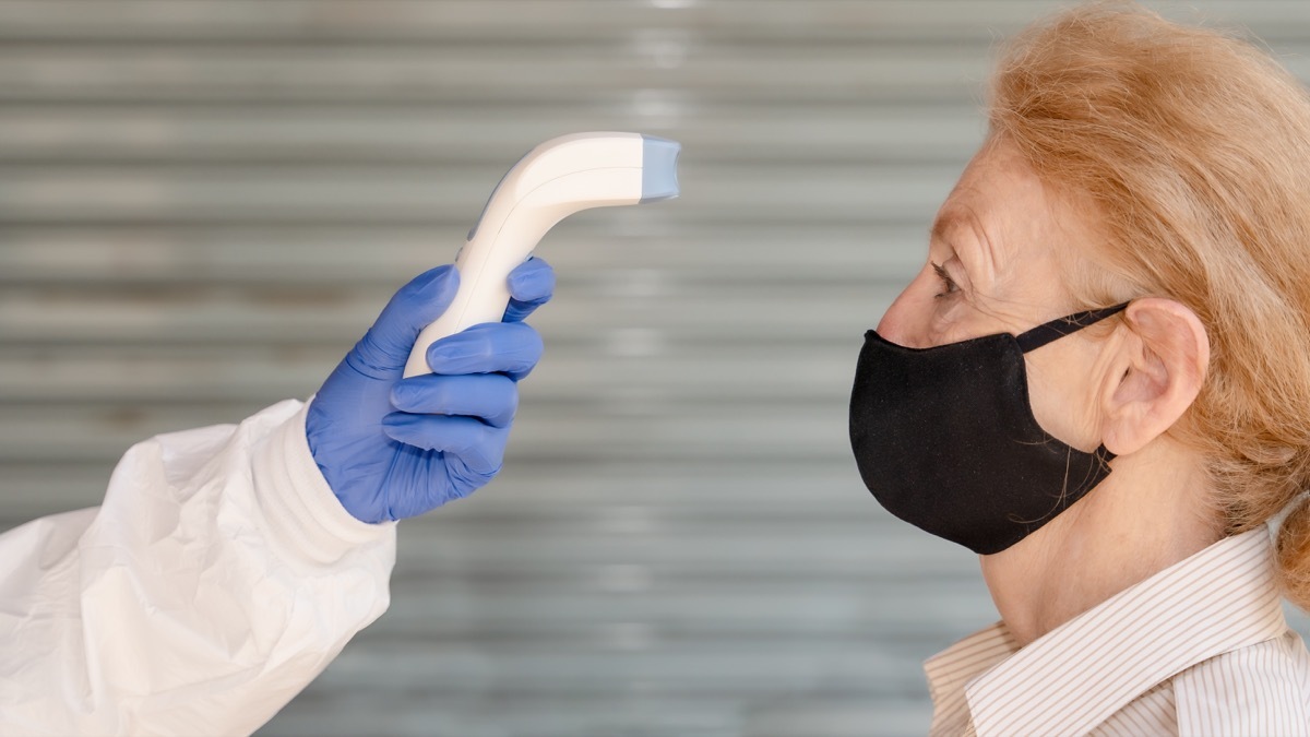 woman over 65 getting her temperature taken