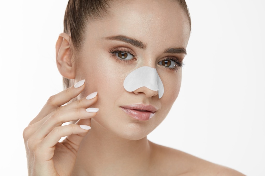 Woman using pore strip Body Flaws