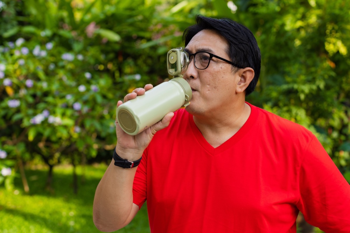 Man drink water from water bottle.