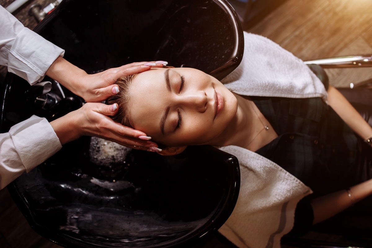 Woman getting her hair shampooed before hair cut