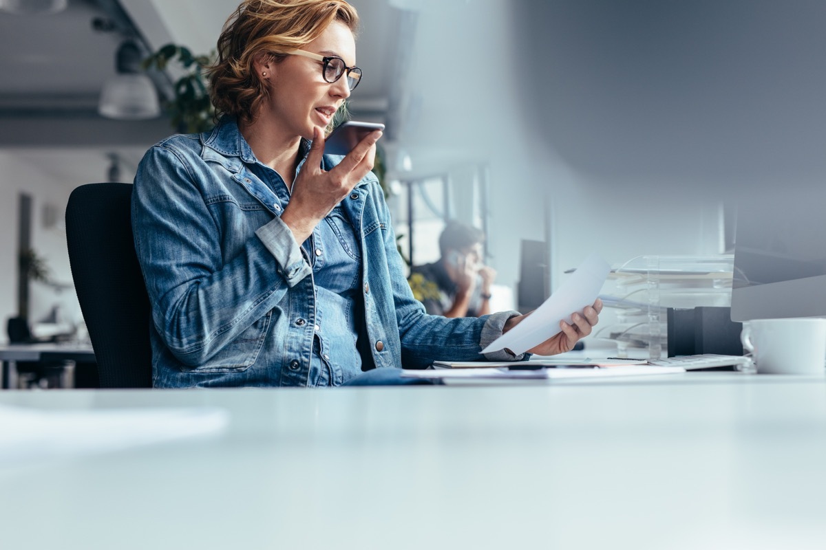 woman using the text speak feature on her iphone