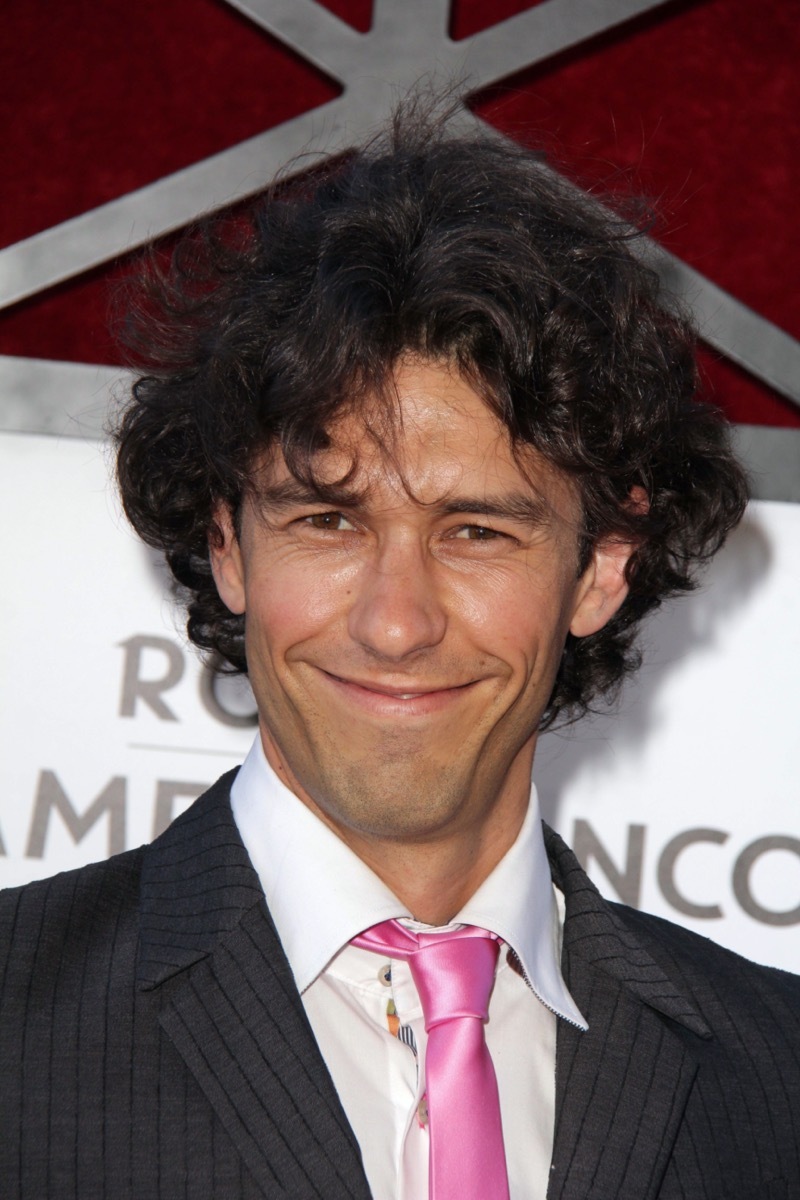 Tom Franco wears black jacket and pink tie in 2013