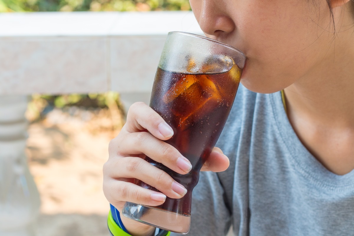 Person drinking sugary soda