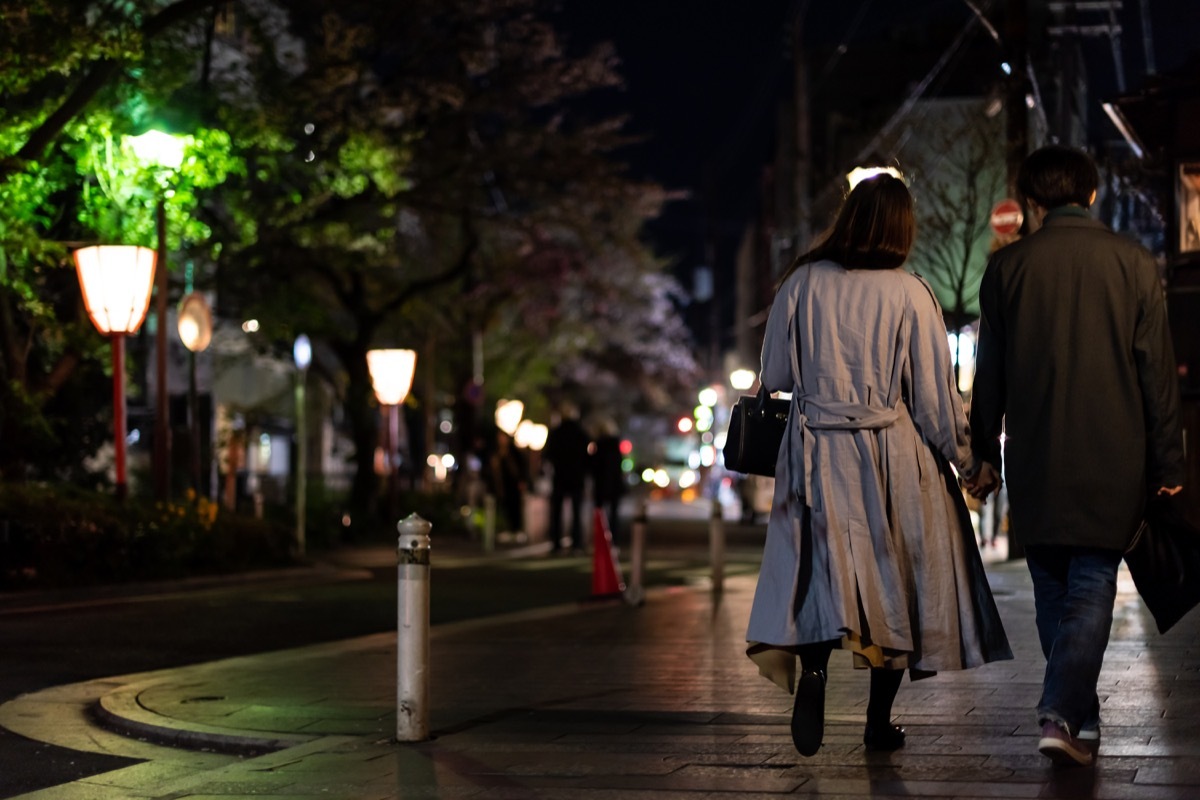 Couple holding hands walk at night