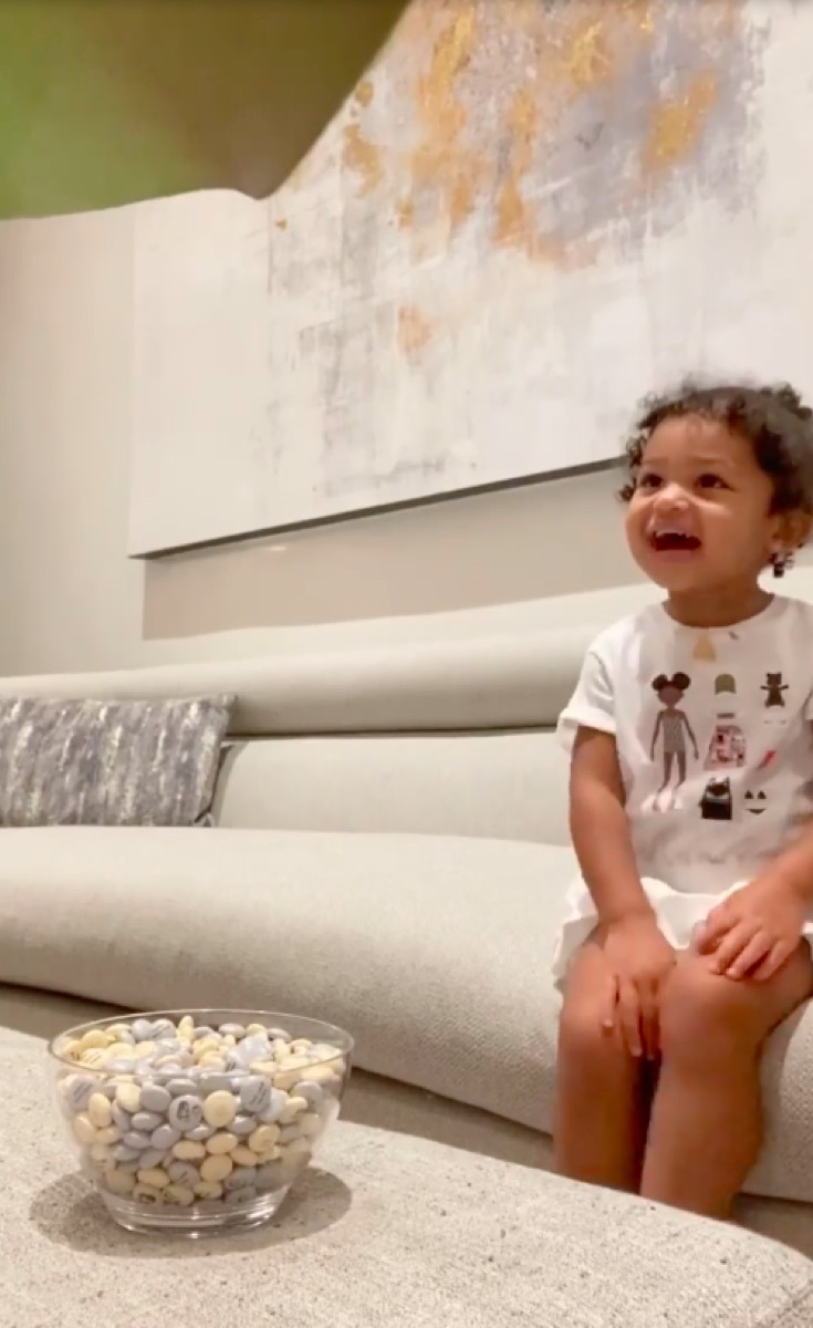 Kylie Jenner's daughter Stormi looking at bowl of candy